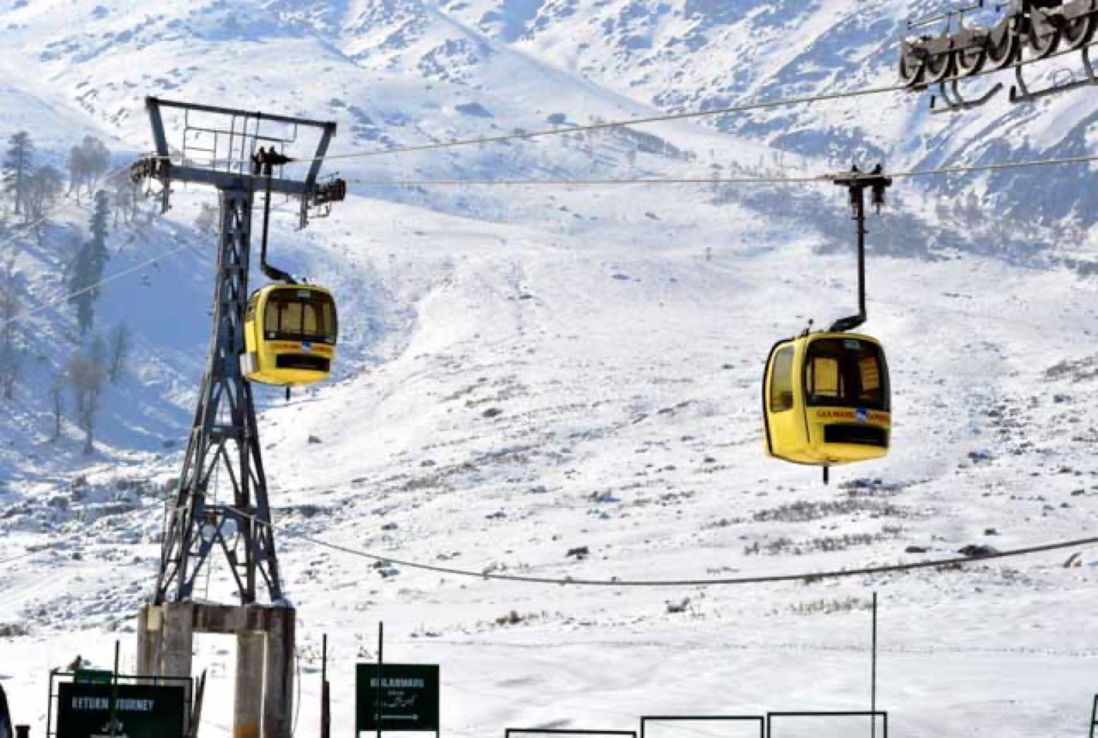 The yellow Gulmarg gondola over snow